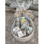 Gift basket with wrapped jars and a large beige bow