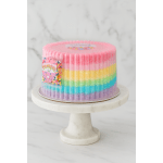 Rainbow frosted cake on a white pedestal stand