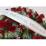 Red rose funeral spray with a white personal message ribbon