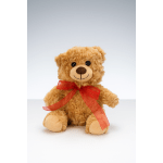 Plush teddy bear with a red ribbon bow