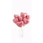 Pink heart-shaped balloons in a clear vase