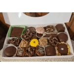 Box of assorted chocolates with a yellow flower accent