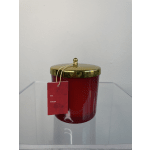 Red candle in a gold-lidded jar with a hanging gift tag