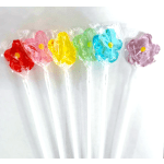 Colorful wrapped lollipops arranged in a row on white sticks
