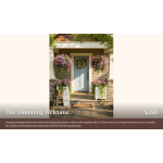 Hanging baskets and planters of pink flowers frame a front door with a wreath.