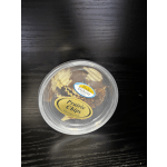 Round plastic tub of assorted candy on a dark table