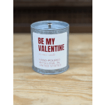 A small candle in a metal tin labeled "Be My Valentine"