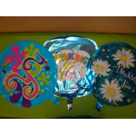 Three round foil balloons with colorful thank-you messages