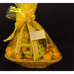Gift basket wrapped in yellow cellophane with fruit and ribbon