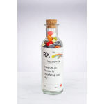 Glass bottle labeled prescription filled with colorful candies and sealed with a cork stopper