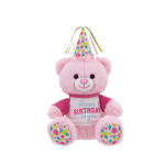 Pink teddy bear wearing a birthday hat and shirt