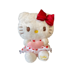 Hello Kitty plush toy holding a pink heart, with a red bow and skirt