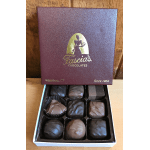 Open box of assorted chocolates with a branded lid