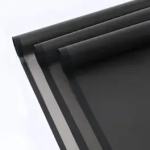 Stack of black wrapping paper sheets on a white background