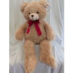 Large beige teddy bear with a red ribbon bow