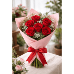 Bouquet of red roses wrapped in pink paper with a red ribbon