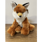 Plush fox toy sitting on a wooden surface