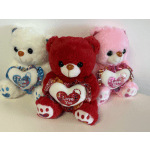Three plush teddy bears holding heart-shaped "I Love You" pillows