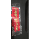Red birthday sash in a clear plastic bag