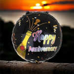 Round black anniversary balloon with champagne bottle graphic and confetti