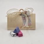 Gift box with ribbon and three small wrapped chocolates