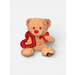 Teddy bear holding a red heart with a red ribbon