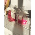 Two wrapped red floral gift bundles tied with white ribbons