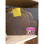 Large boxed assortment of chocolates with a gold rose design and yellow gift tag