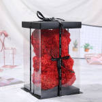 Red rose teddy bear in a clear gift box with a black ribbon