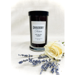 Black candle jar with a cream rose and lavender sprigs