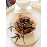Chocolate bark pieces in a pink paper cup on a floral plate