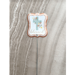 Decorative cross sign on a metal stake with floral accents and the word blessed