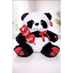 Plush panda bear holding red heart decorations and a ribbon