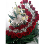 Red roses and white lilies arranged with baby's breath
