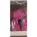 Pink rose bouquet wrapped in clear plastic with a black ribbon