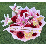 Bouquet of red and pink roses with pink lilies and a Valentine ribbon
