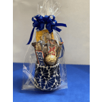 Gift bag with candy bars and a gold chocolate in a patterned mug
