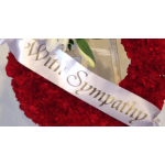 Red floral wreath with a sympathy ribbon