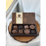 Box of assorted chocolates on a wooden slab