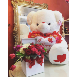 White teddy bear with a heart and a box of red and pink roses
