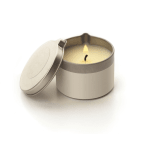 Lit candle in a round metal tin with a lid beside it