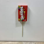 Skittles candy package mounted on a wooden stick