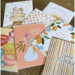Assorted birthday greeting cards with colorful illustrated covers