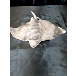 Gray plush manta ray toy on a dark surface