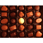 Assorted chocolates in a box with molded tops