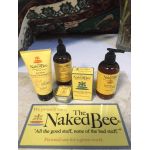 Naked Bee personal care products displayed on a counter with a branded sign