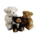Three plush teddy bears in white, tan, and black sitting close together on a plain background