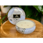 Decorative three-wick candle in a patterned tin container