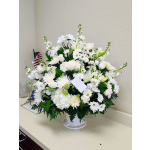 White floral arrangement in a white vase with daisies and roses