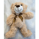 Plush teddy bear with a ribbon bow on a white furry background